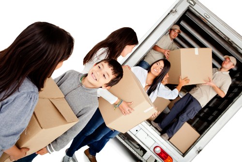 Packed boxes and furniture being loaded into a removal truck