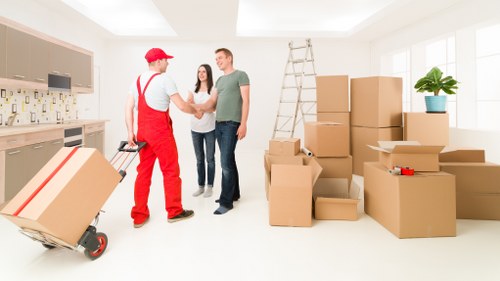 Loading furniture into a van on a Putney residential street