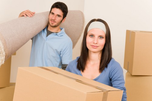 Packed boxes and moving equipment in a Putney flat move